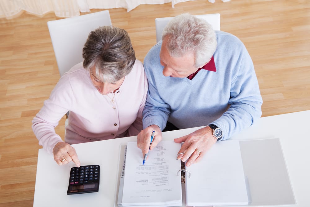 Photo of Senior Couple Calculating Budget At Home, Sell my Mortgage Note